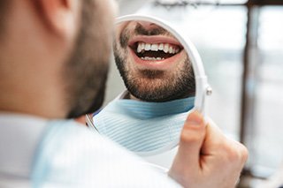 Patient looking at smile in reflection