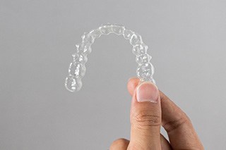 Patient holding clear aligner