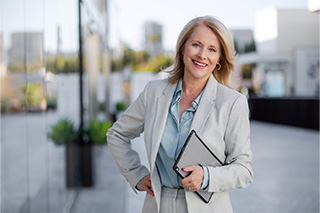 Businesswoman with dental implants in Fort Worth smiling outside