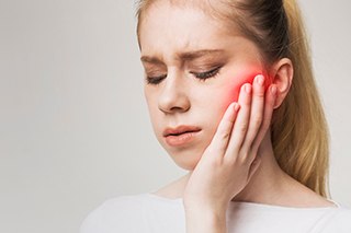 An unhappy woman suffering from a toothache
