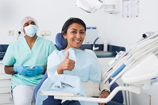 a dental patient giving a thumbs up