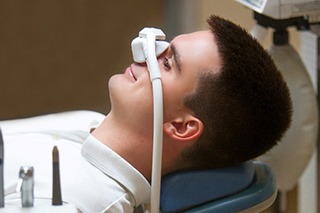 Man relaxing in treatment chair while inhaling nitrous oxide