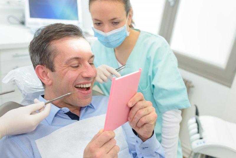 Man smiling at his new dental implants