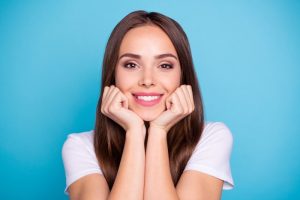 a woman smiling with bright teeth from a cosmetic dental treatment