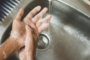 dentist following safety procedures by washing hands