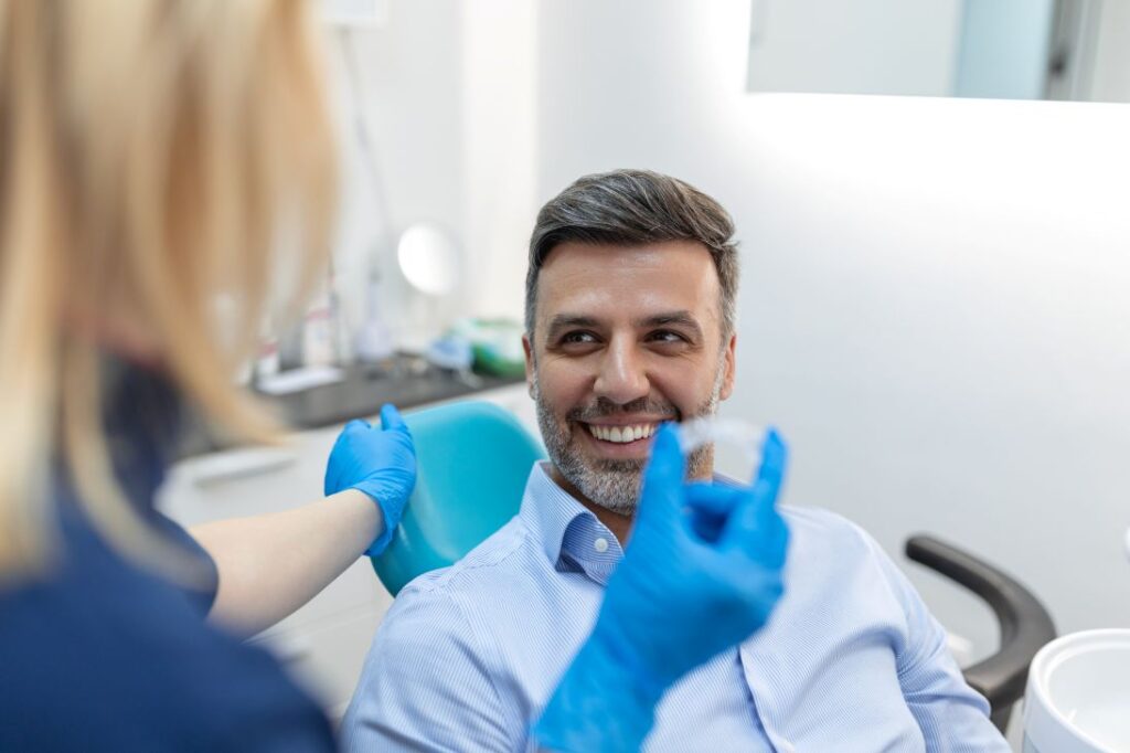A man getting Invisalign treatment from a dentist