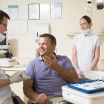 Man talking to dentist in dental chair