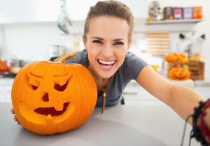 Woman with carved pumpkin