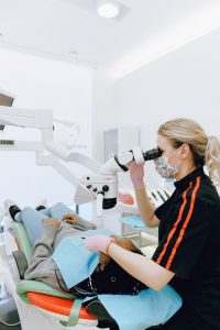 Dentist using dental implant technology.